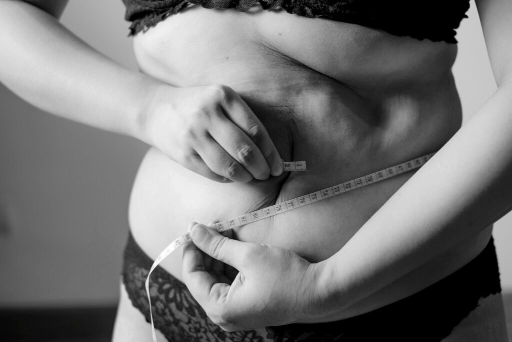 How to Reduce Belly Fat? - Person measuring body fat