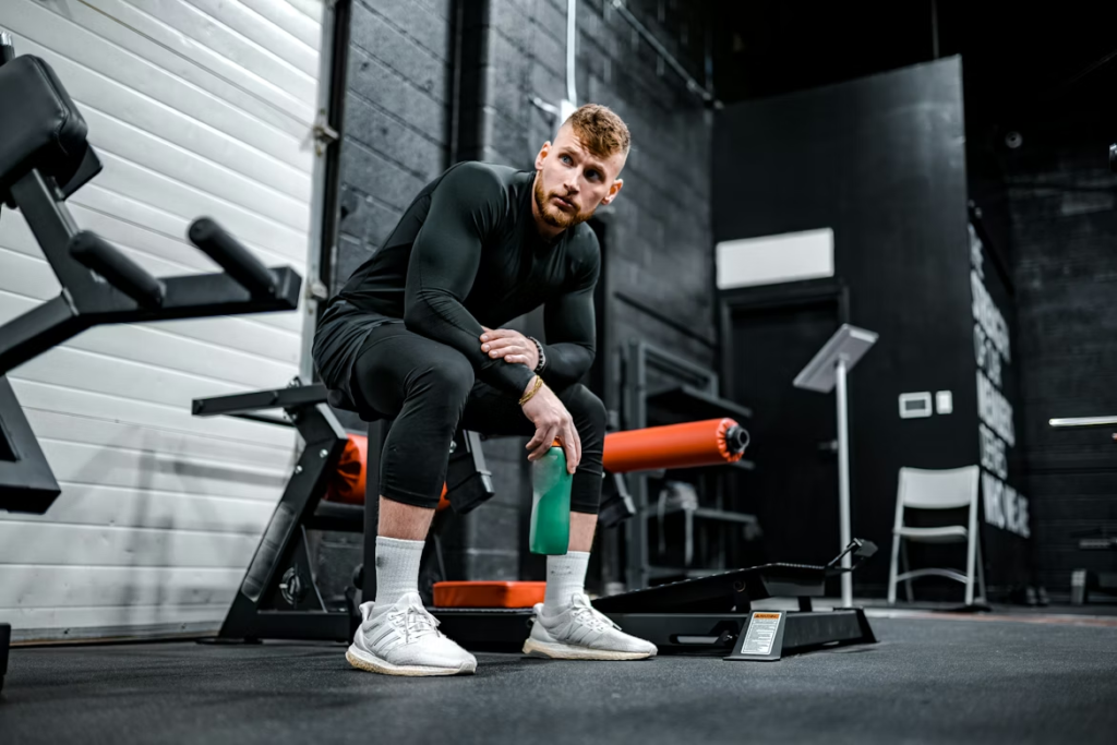 What Are Signs of Overtraining - Person Resting in the gym